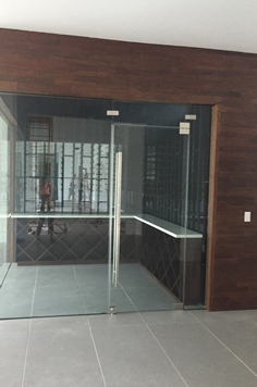 glass door wine cellar with wood framing