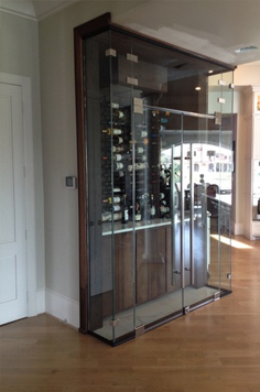 glass door wine cellar with wood framing